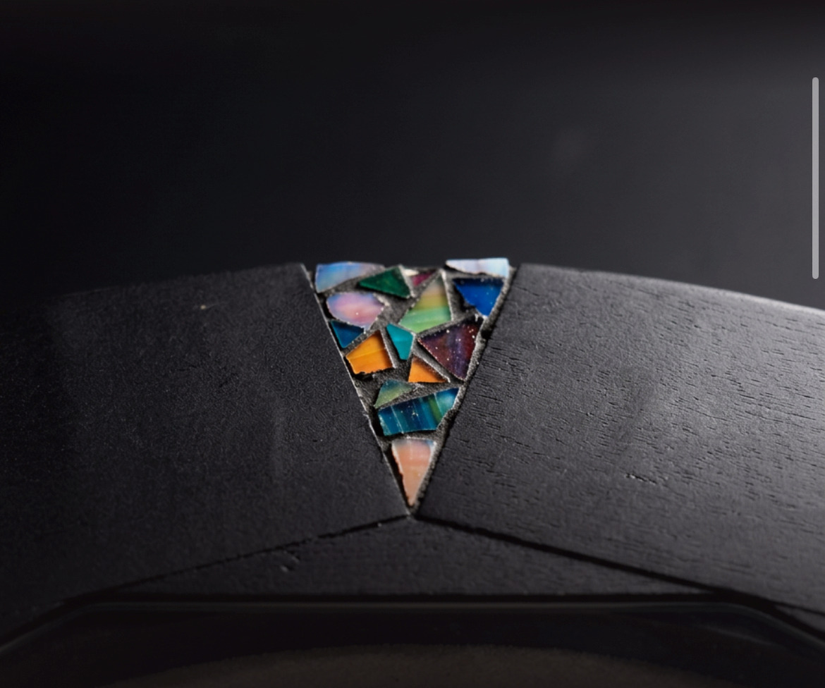 Hand-set mosaic detail on the lacquered frame